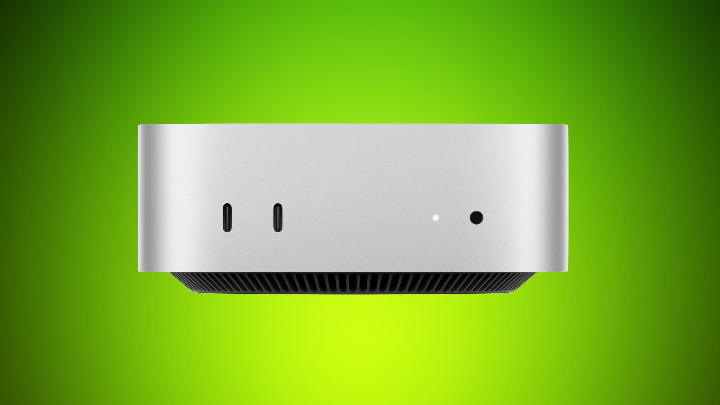 Mac Studio y Mac Mini sobre una mesa de madera, con un fondo de circuitos de memoria borrosos