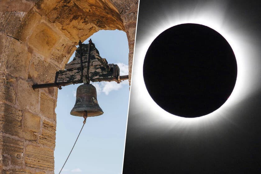 Campanario de iglesia en un pueblo de Navarra con el cielo parcialmente oscurecido por un eclipse solar